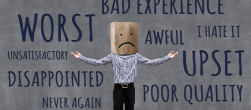 Angry customer with paper bag over head and sad face on it